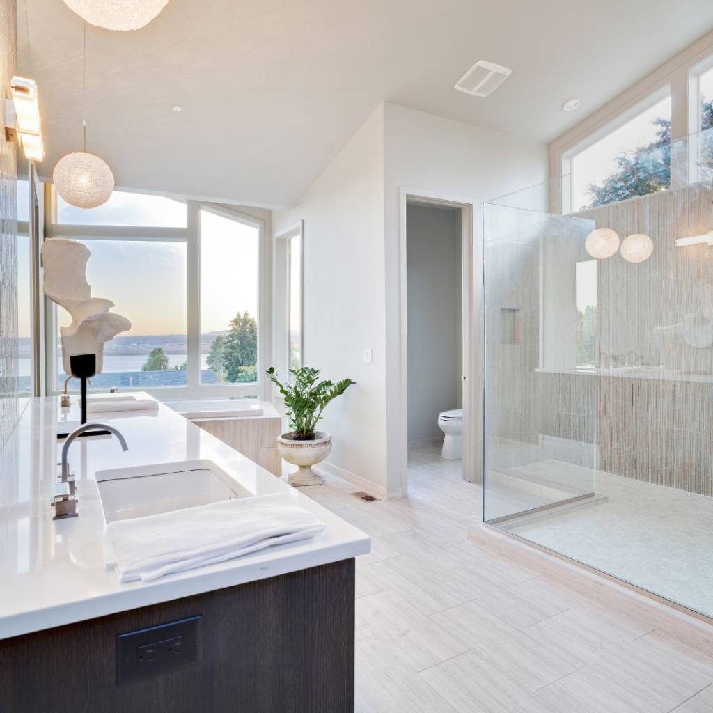 Bright coastal bathroom decor with whites and natural light and a view of the water