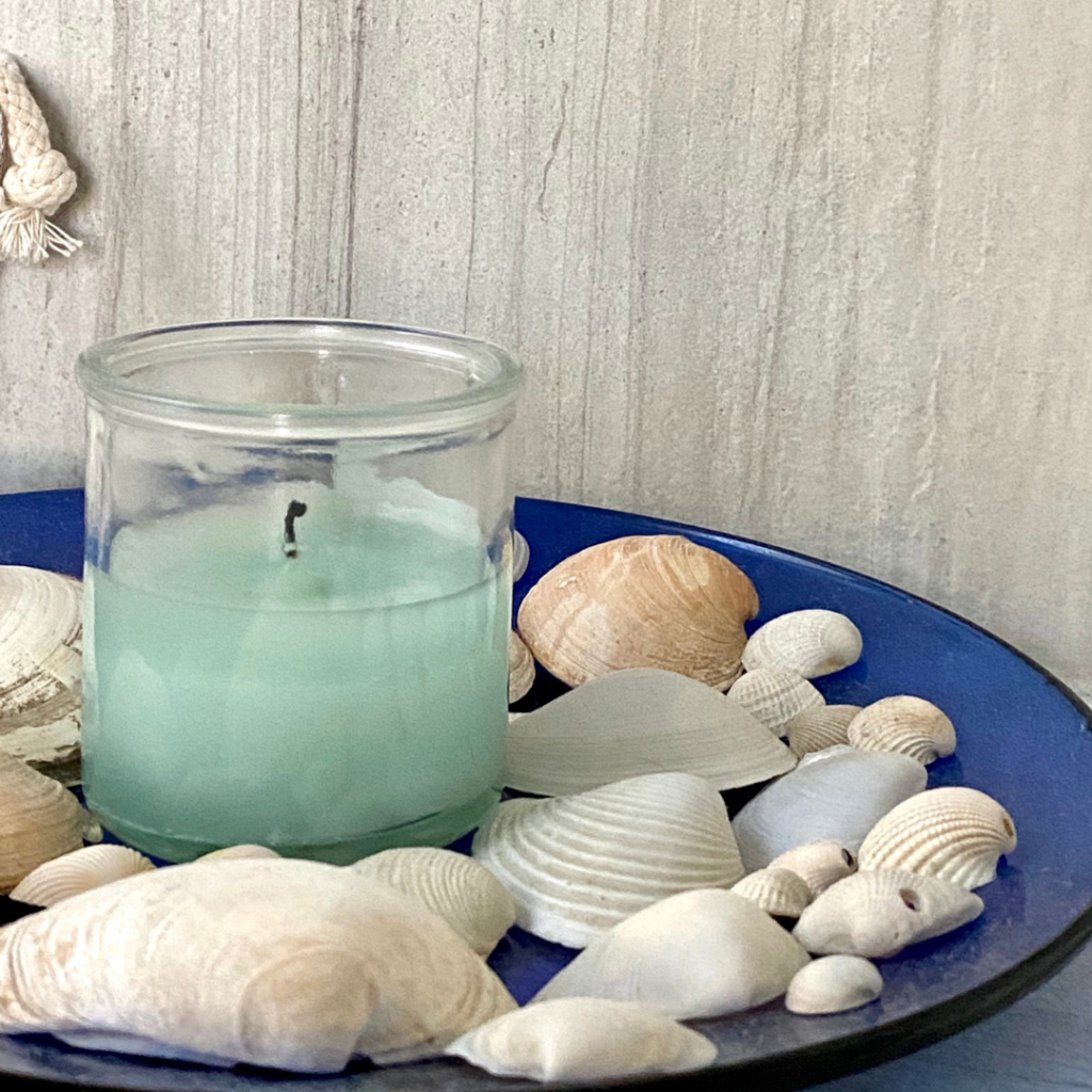 Coastal candle with seashells on a charger display plate