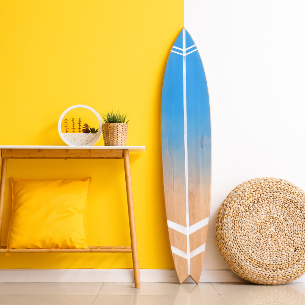 Surf Shack Chic with a surfboard, bright colors, wooden furniture and natural fiber basket decoration